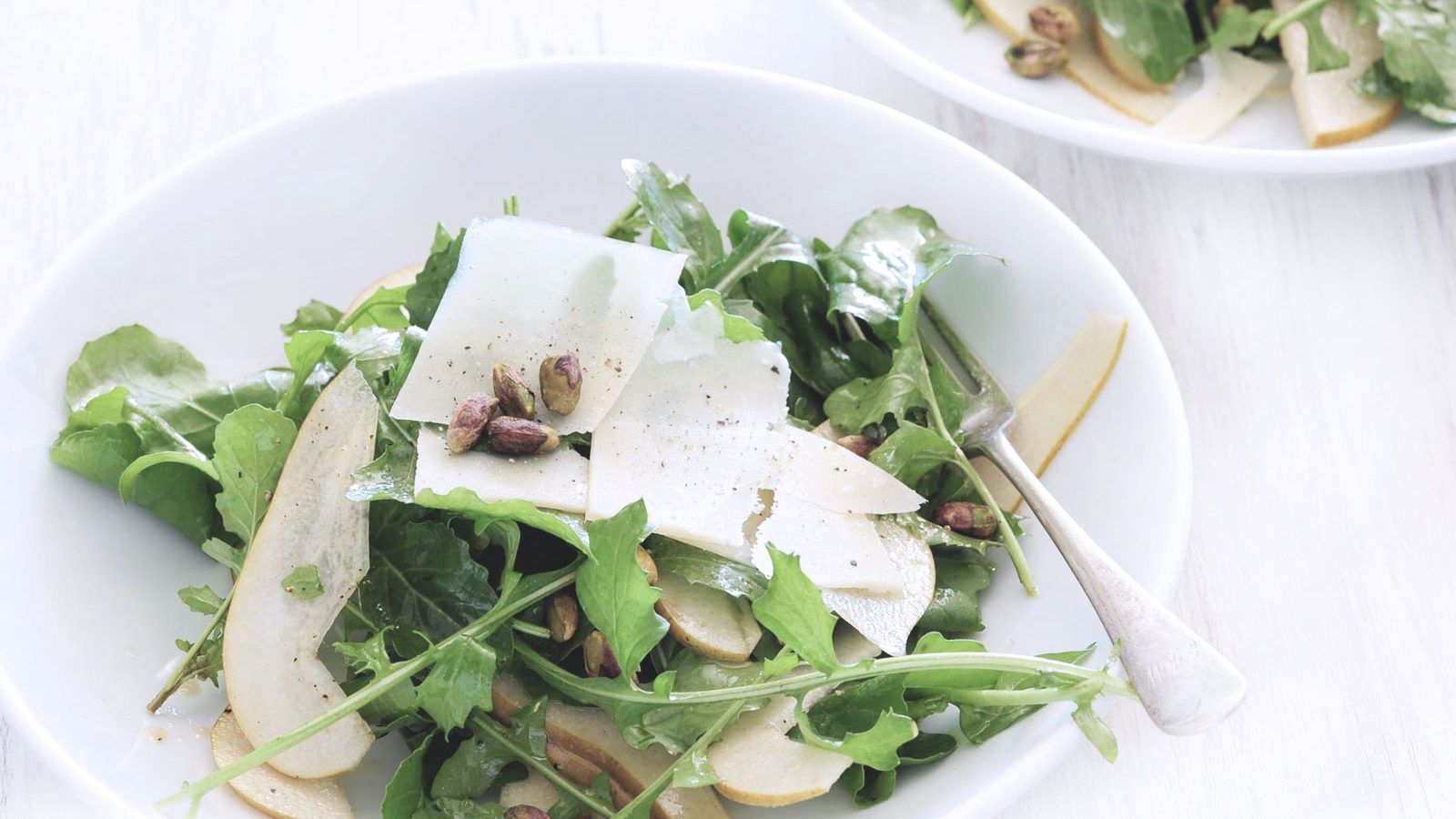 Finely sliced raw artichoke hearts and rocket lettuce topped with parmesan cheese